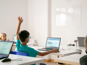 mixed-race-boy-glasses-rising-hand-answer-lesson.jpg